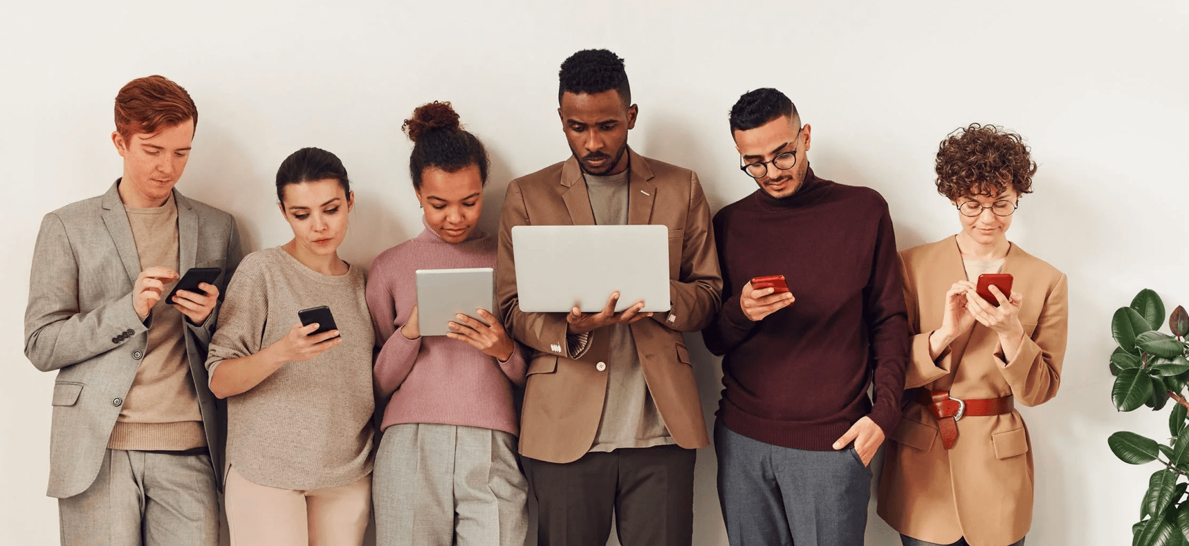 Group of people standing with mobile and tablet